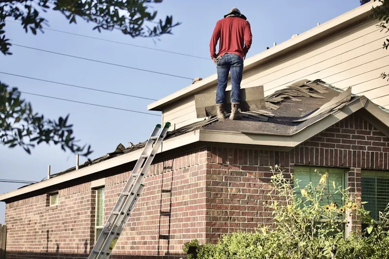 Professional roofer working on a residential roof in Senatobia